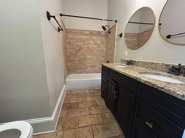 a bathroom with a granite countertop sink a mirror a vanity and bathtub