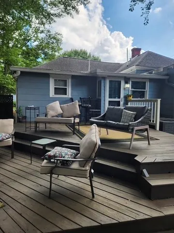 a roof deck with table and chairs