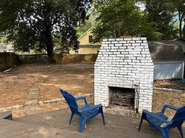 a building outdoor space with patio furniture and a fireplace
