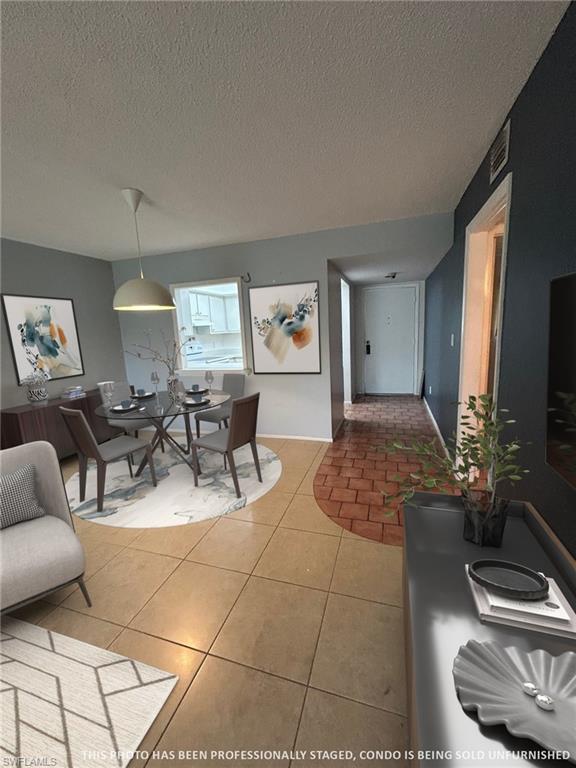 5651 Rattlesnake Hamm Road, Unit C107 Naples, FL 34113 - Photo 7 of 20 LIVING ROOM AREA THAT LEADS INTO THE DINING ROOM