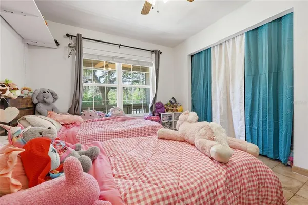 a bedroom with a bed and large windows