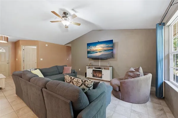 a living room with furniture and a flat screen tv