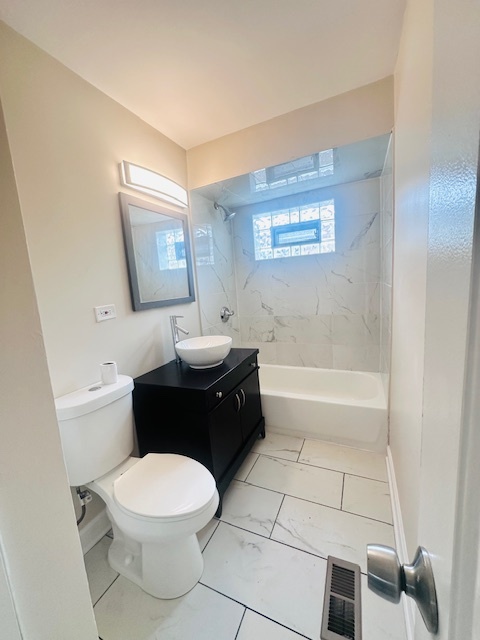 9508 South Green Street Chicago, IL 60643 - Photo 12 of 47 a bathroom with a toilet a sink and bathtub