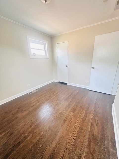 9508 South Green Street Chicago, IL 60643 - Photo 8 of 47 an empty room with wooden floor and windows