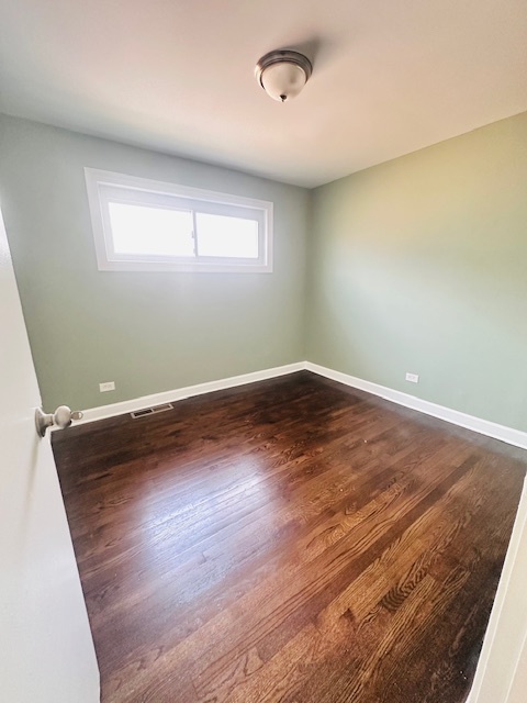 9508 South Green Street Chicago, IL 60643 - Photo 10 of 47 an empty room with wooden floor and windows
