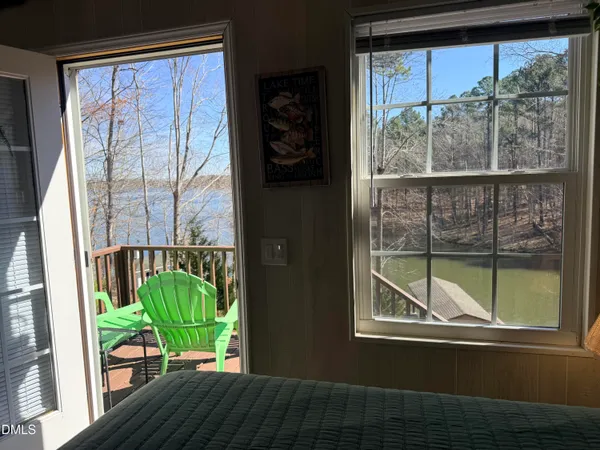 a view of a balcony with furniture and a potted plant