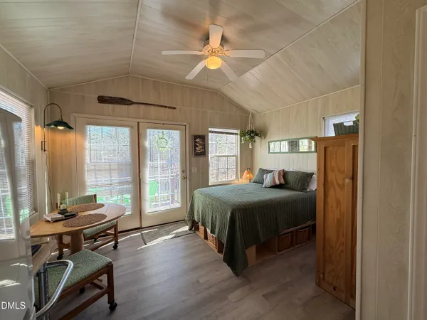 a bedroom with a bed and a chandelier