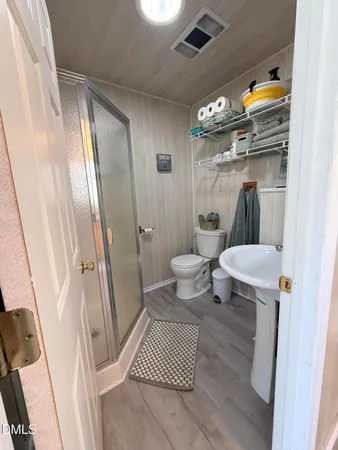 a bathroom with a toilet a sink and a shower