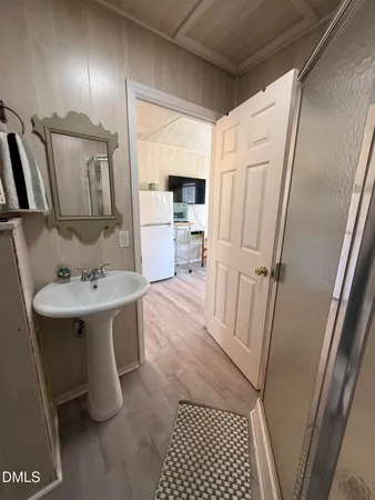 a bathroom with a sink a mirror and a shower