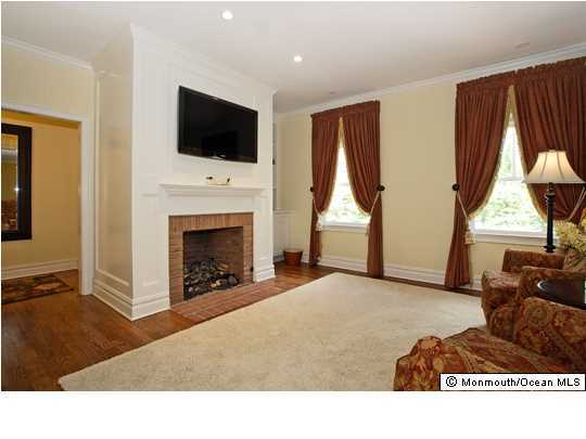15 Heathcliff Road Rumson, NJ 07760 - Photo 15 of 22 a living room with furniture a fireplace and a flat screen tv