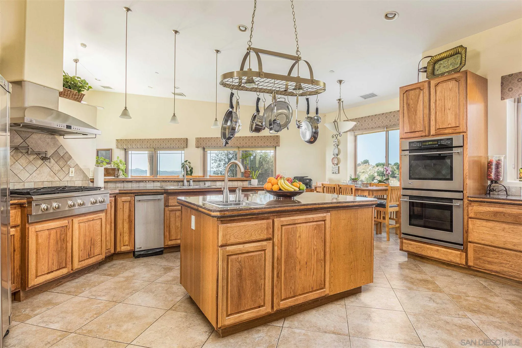 29482 Paso Robles Road Valley Center, CA 92082 - Photo 12 of 37 a kitchen with stainless steel appliances granite countertop a stove a sink and a refrigerator