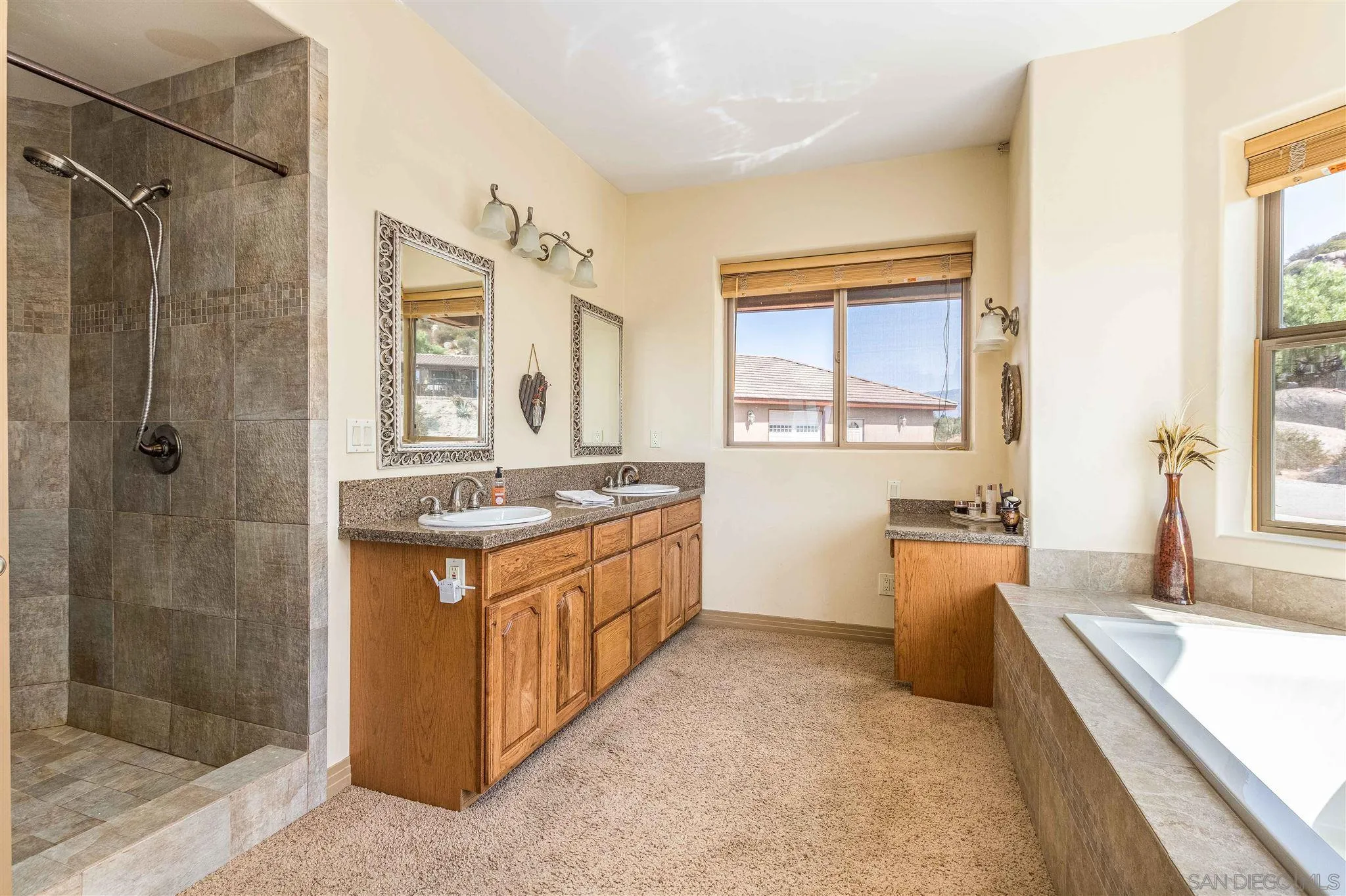 29482 Paso Robles Road Valley Center, CA 92082 - Photo 25 of 37 a large bathroom with a granite countertop tub sink shower and mirror