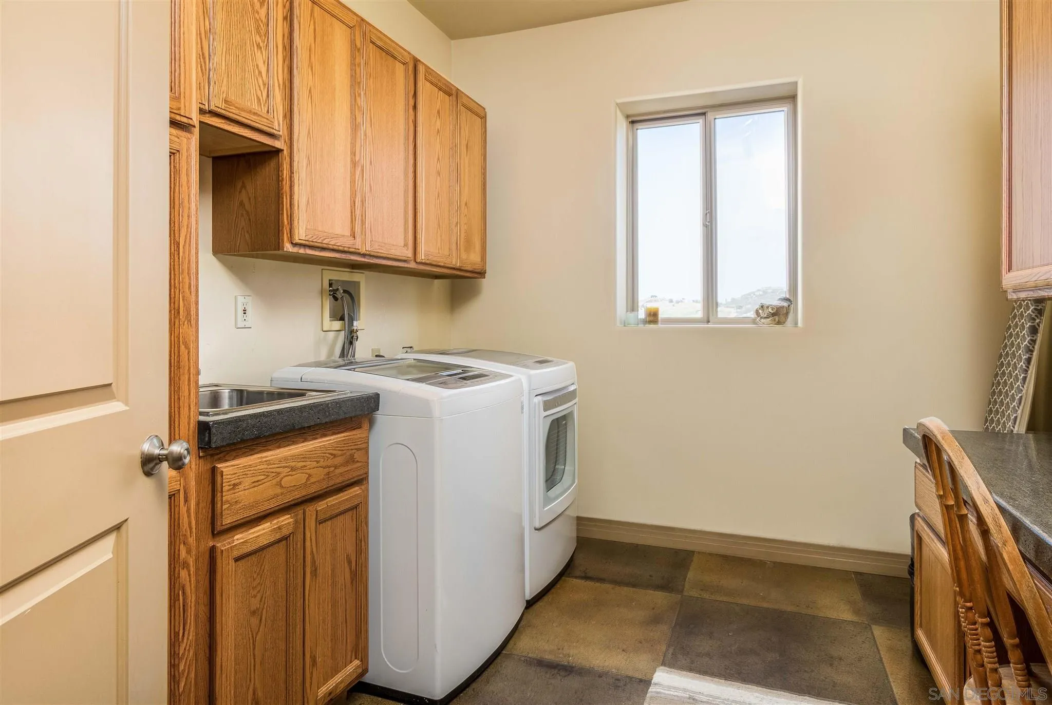 29482 Paso Robles Road Valley Center, CA 92082 - Photo 33 of 37 a utility room with wooden floor washer and dryer