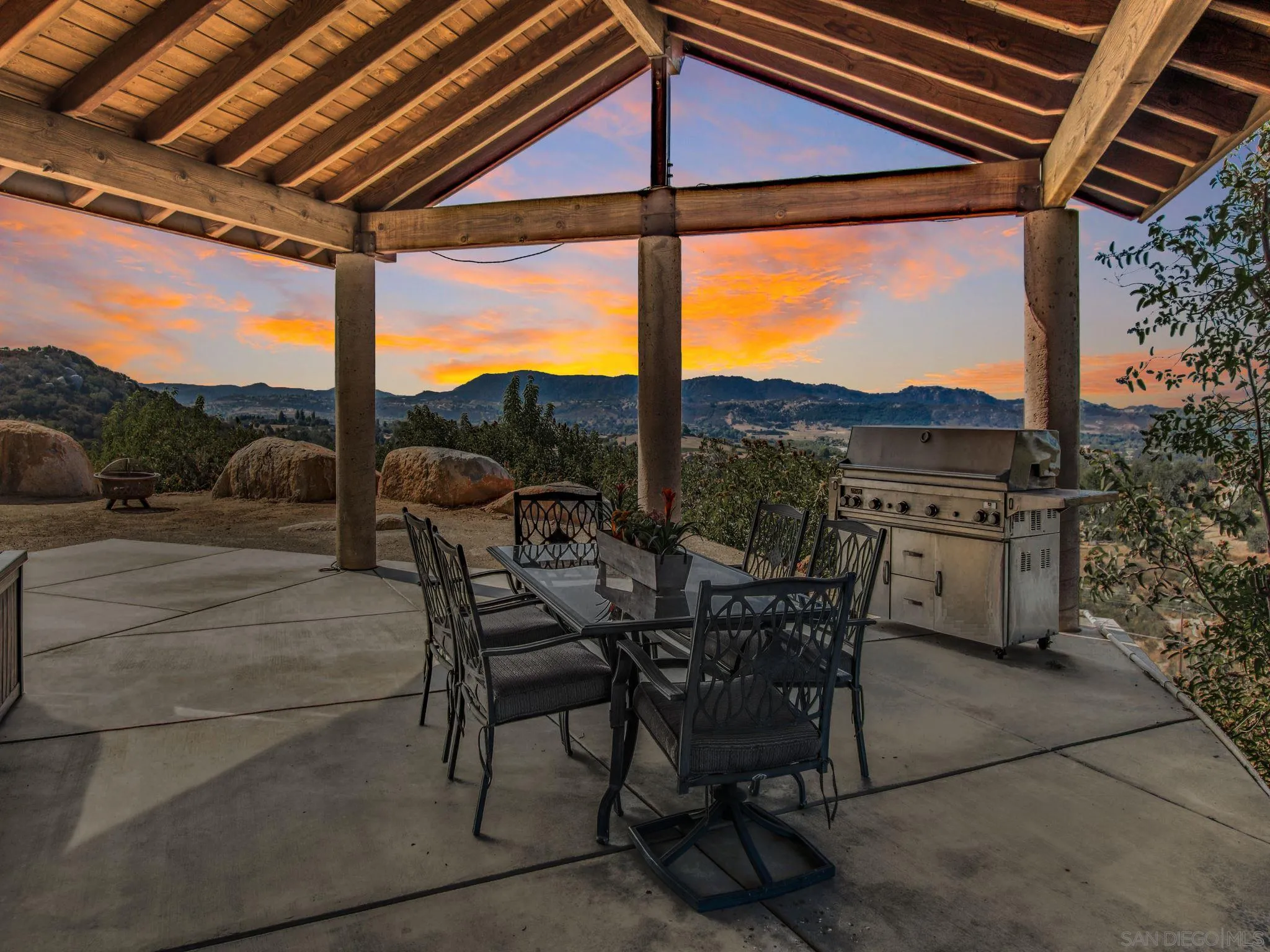 29482 Paso Robles Road Valley Center, CA 92082 - Photo 34 of 37 a view of a patio with a table chairs and a backyard