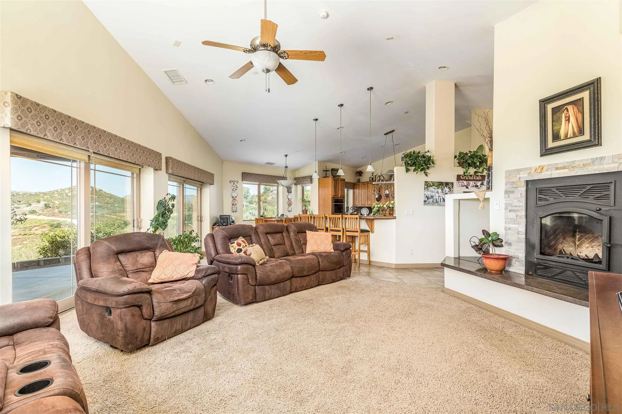29482 Paso Robles Road Valley Center, CA 92082 - Photo 8 of 37 a living room with furniture and a fireplace