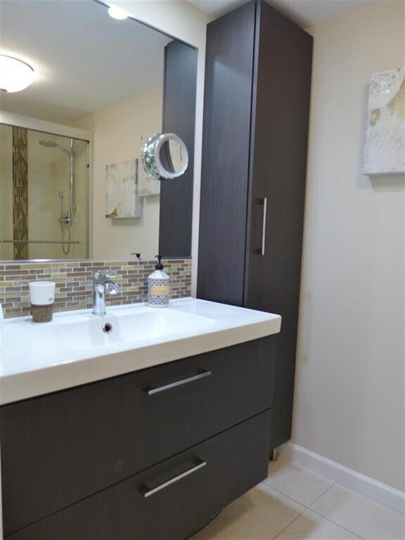 605 Oaks Drive, Unit 503 Pompano Beach, FL 33069 - Photo 12 of 15 a bathroom with a sink and a mirror