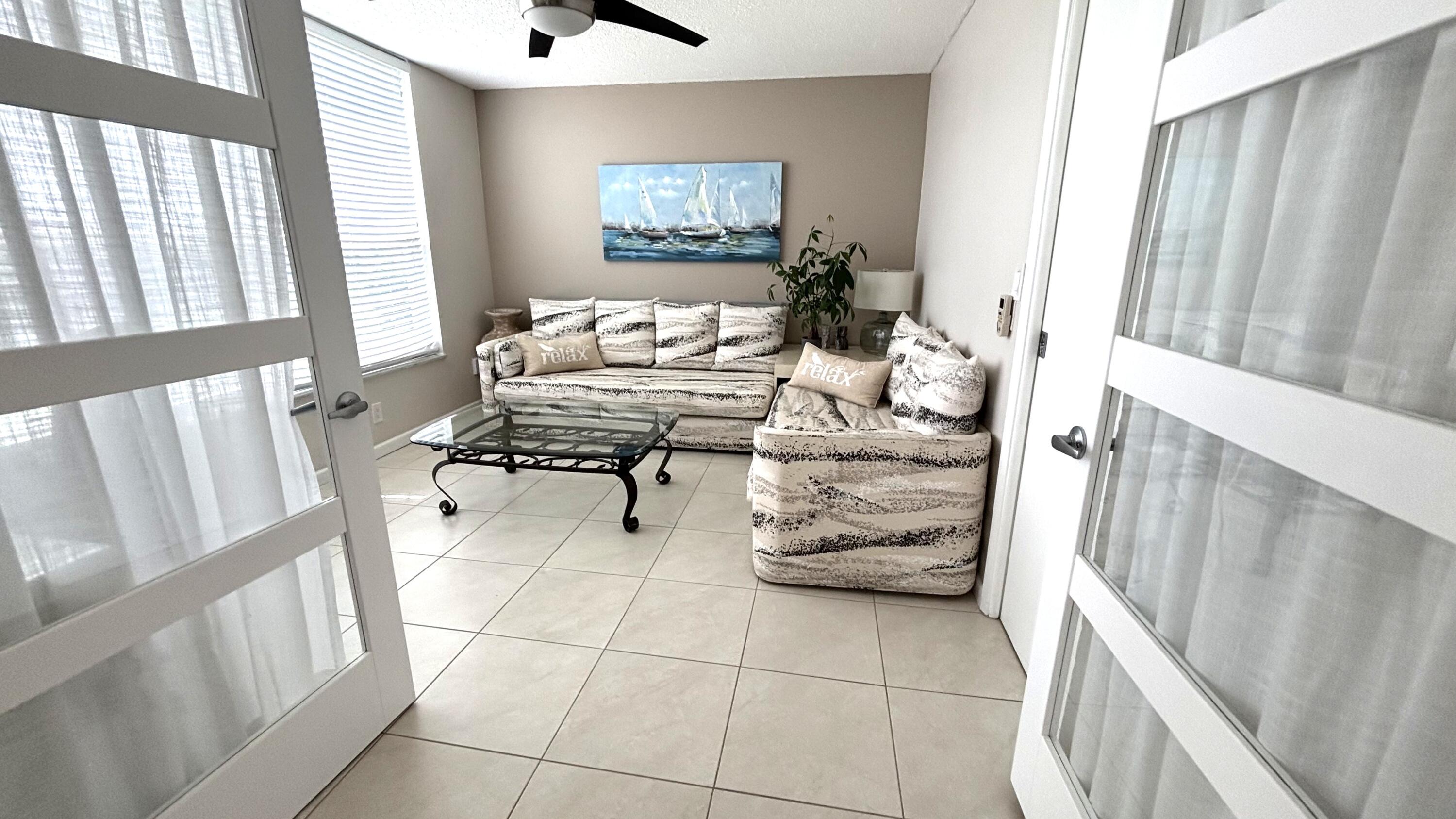 605 Oaks Drive, Unit 503 Pompano Beach, FL 33069 - Photo 6 of 15 a bedroom with furniture and a window