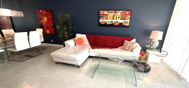 a view of a dining room with furniture and a potted plant
