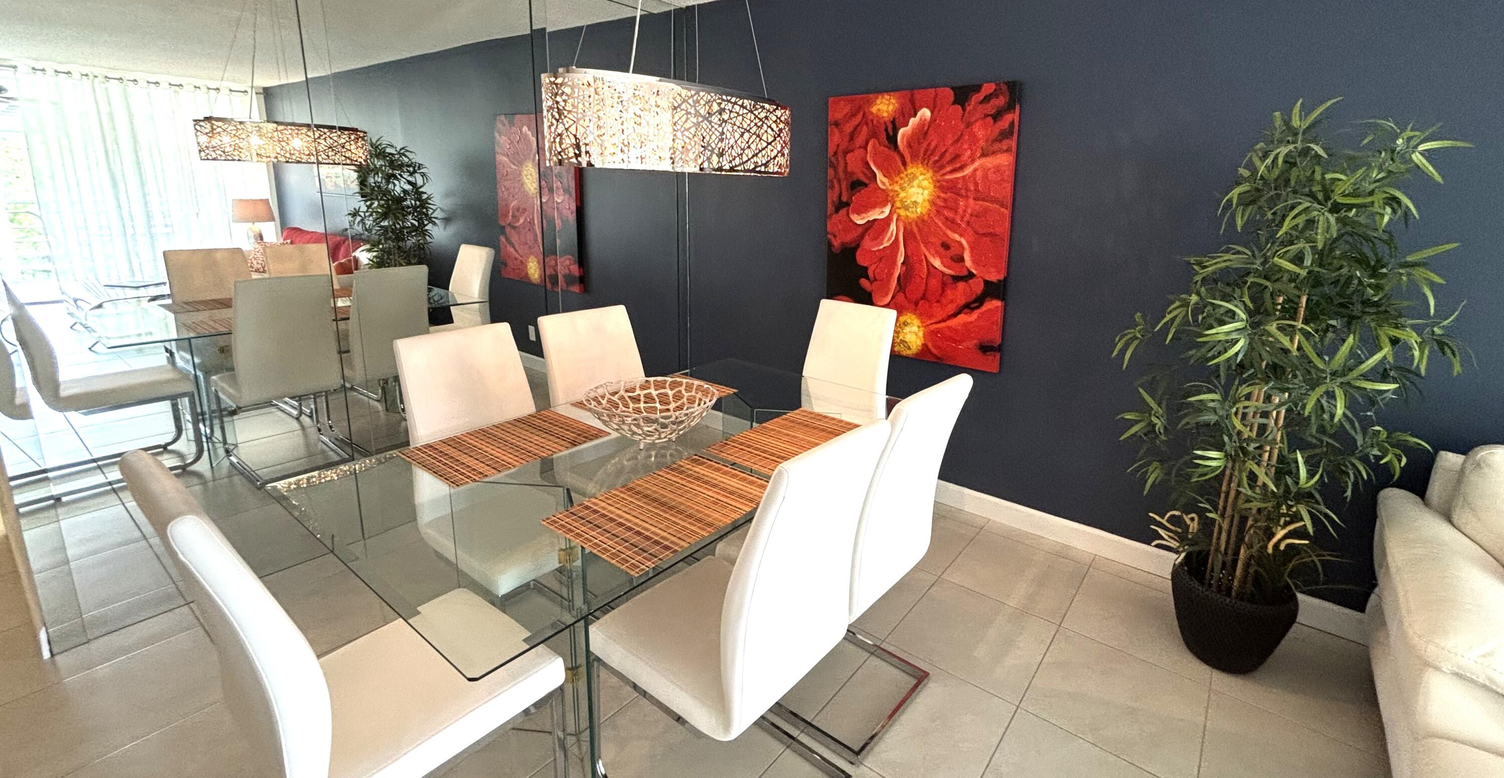 605 Oaks Drive, Unit 503 Pompano Beach, FL 33069 - Photo 10 of 15 a view of a dining room with furniture and a potted plant