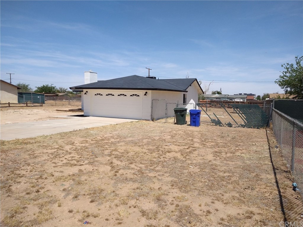 22380 Kayenta Road Apple Valley, CA 92308 - Photo 1 of 1 a view of a dry yard with wooden fence
