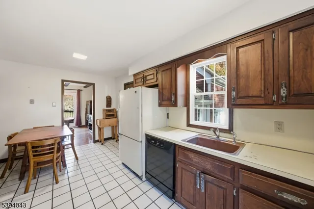 a kitchen with a stove cabinets and a refrigerator