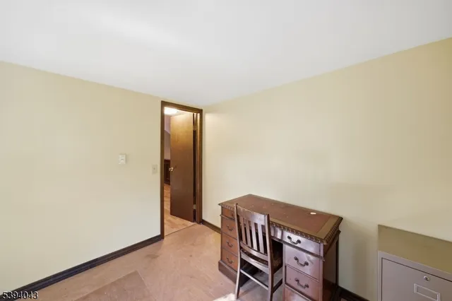 a view of room with window and wooden floor