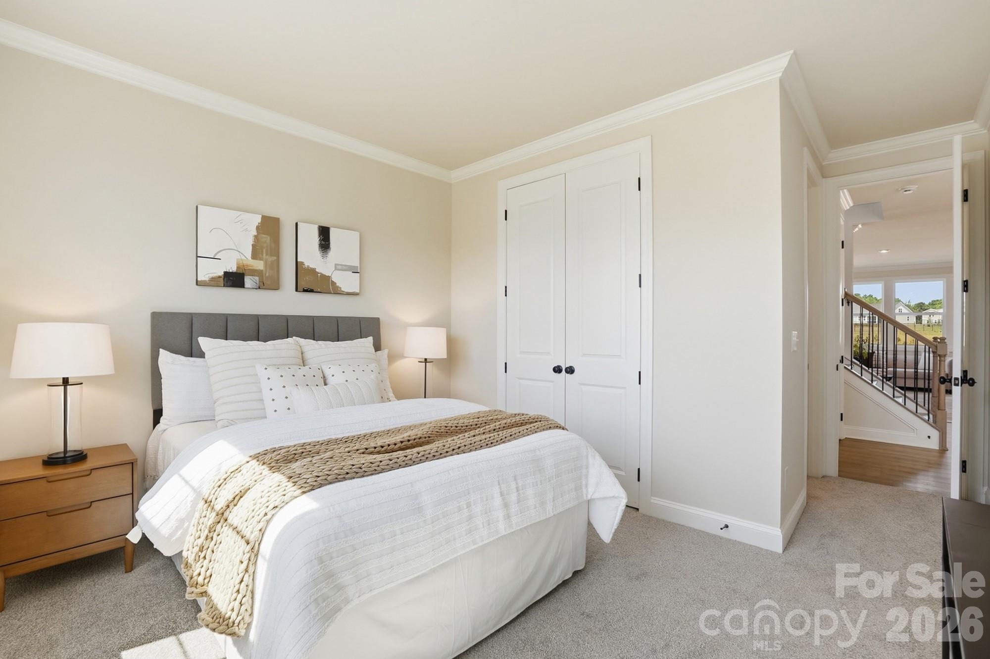2608 Mabel Lane Monroe, NC 28110 - Photo 18 of 36 a bedroom with a bed and a lamp