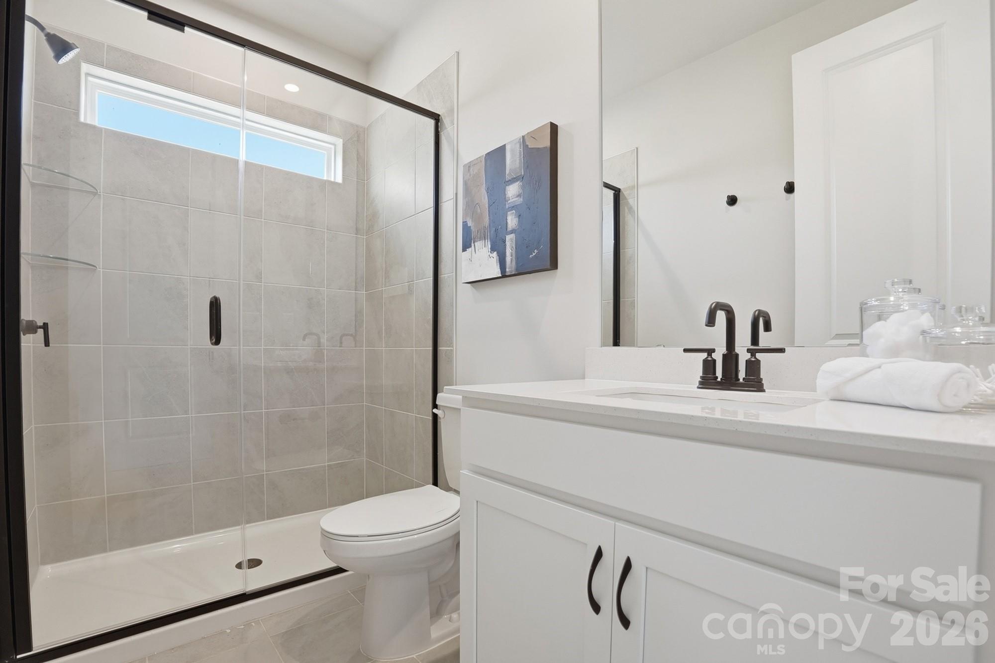 2608 Mabel Lane Monroe, NC 28110 - Photo 19 of 36 a bathroom with a sink a toilet and shower