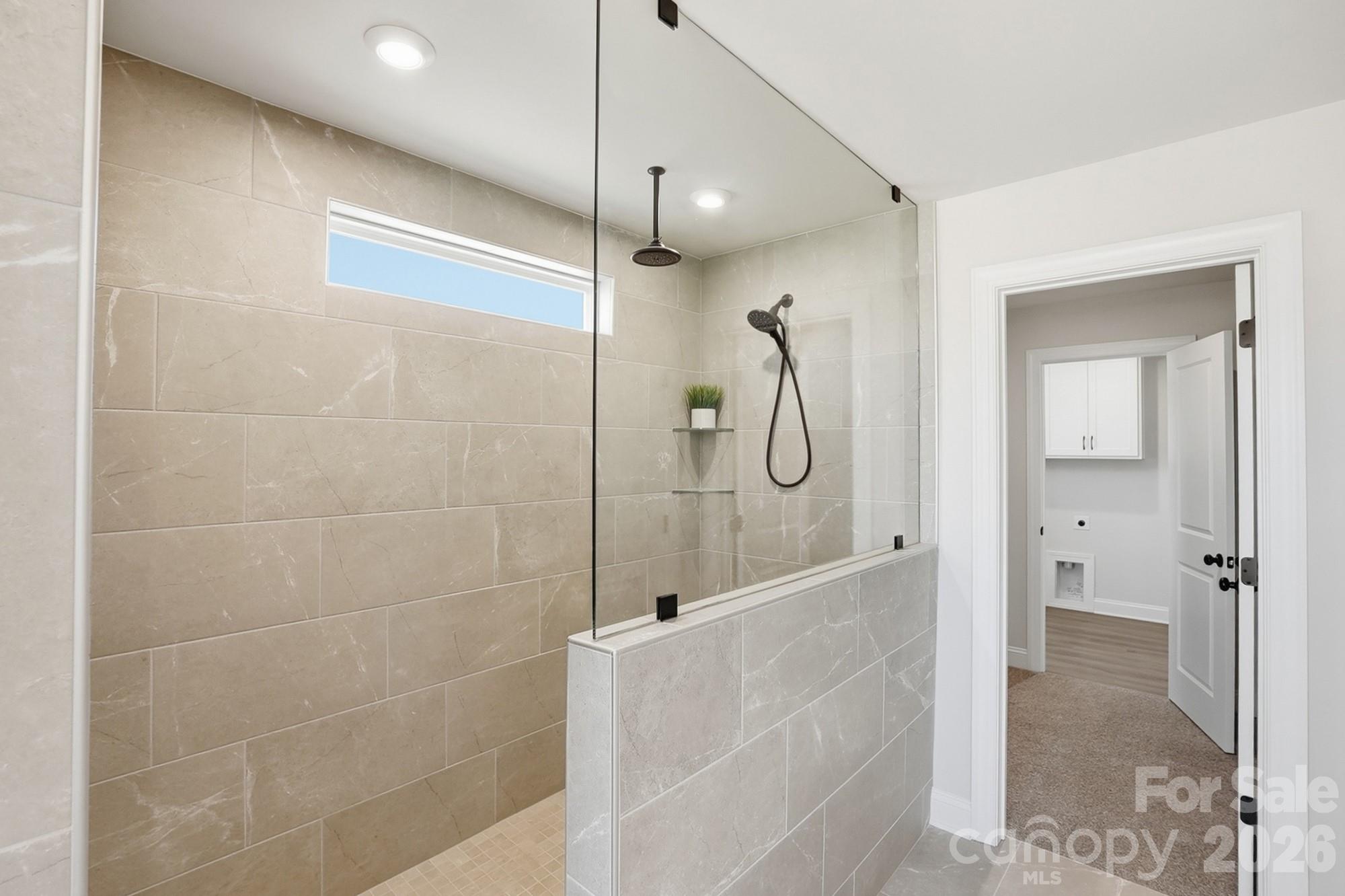 2608 Mabel Lane Monroe, NC 28110 - Photo 22 of 36 a bathroom with a glass shower door