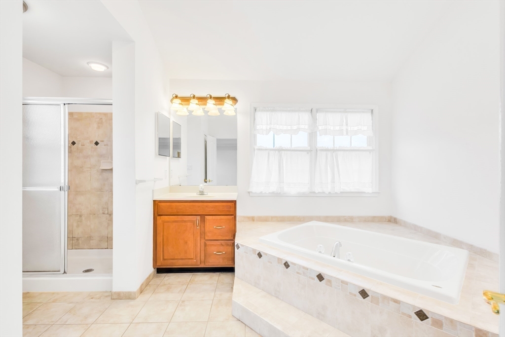 45 Endean Drive Walpole, MA 02032 - Photo 20 of 42 a bathroom with a tub sink and mirror