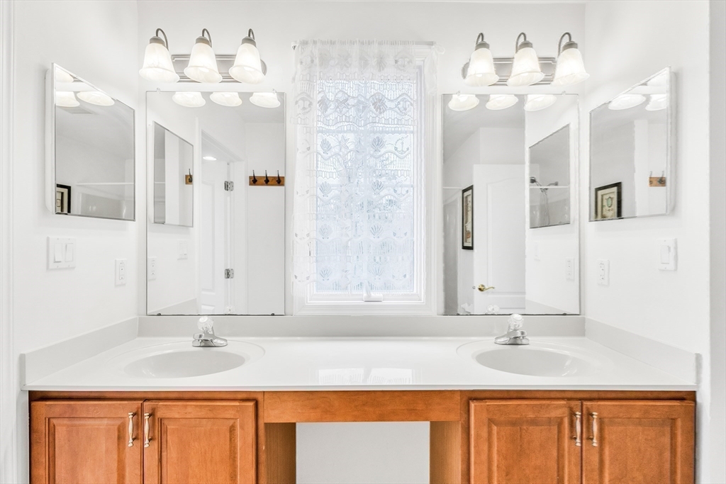 45 Endean Drive Walpole, MA 02032 - Photo 26 of 42 a bathroom with a granite countertop sink and a mirror