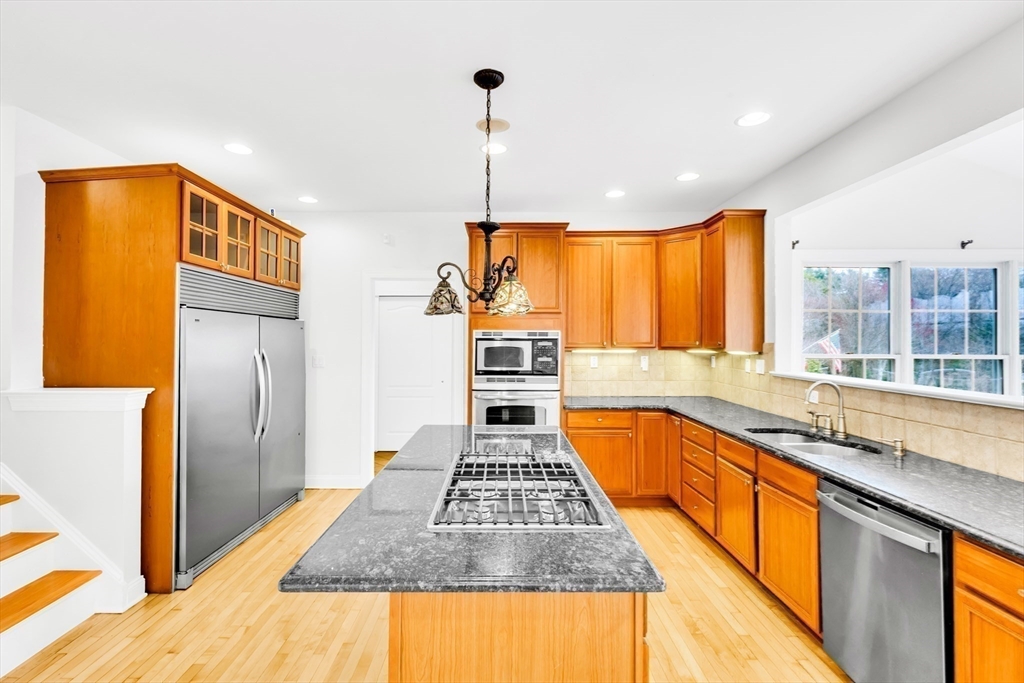 45 Endean Drive Walpole, MA 02032 - Photo 10 of 42 a kitchen with stainless steel appliances granite countertop a stove a sink and a refrigerator