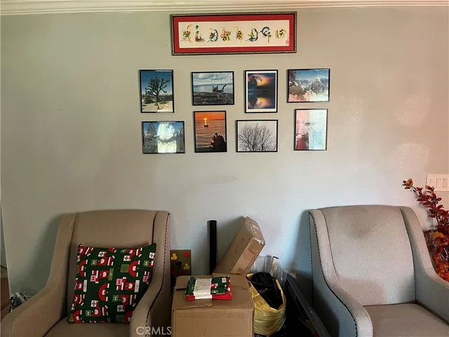 a living room with furniture and baby chair
