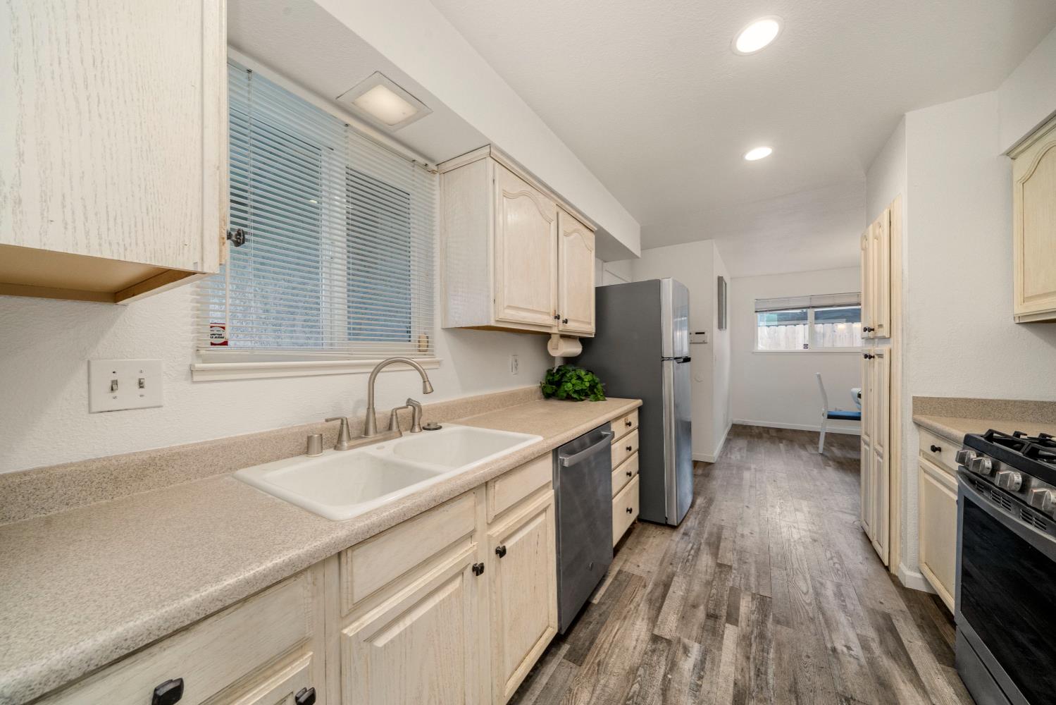 7358 Candlelight Way Citrus Heights, CA 95621 - Photo 11 of 45 a kitchen with a sink stove and refrigerator
