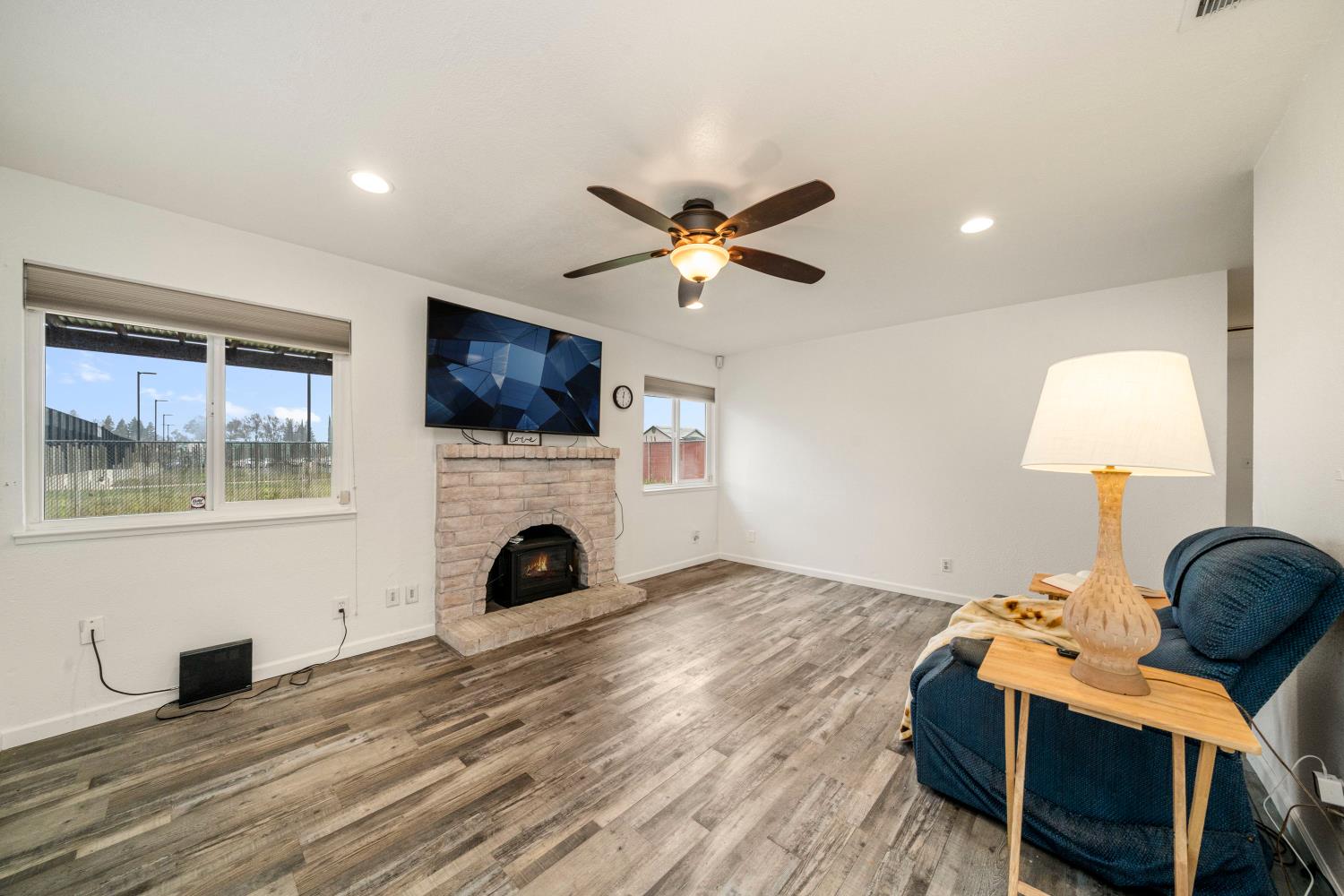 7358 Candlelight Way Citrus Heights, CA 95621 - Photo 14 of 45 a living room with furniture a fireplace and a flat screen tv