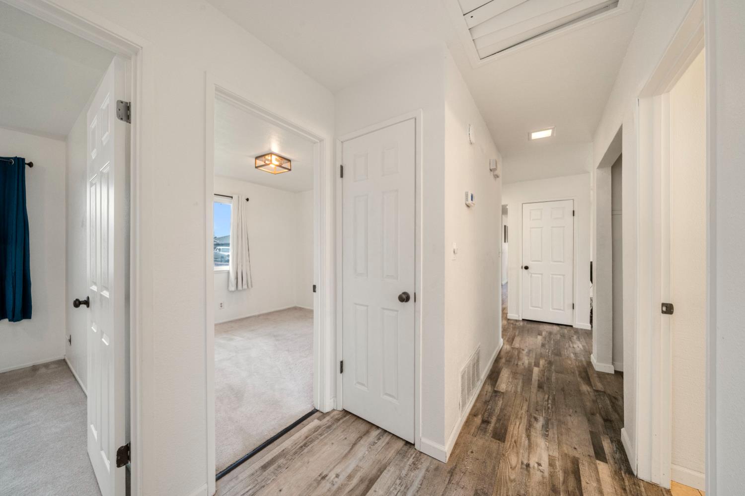 7358 Candlelight Way Citrus Heights, CA 95621 - Photo 23 of 45 a view of a hallway with wooden floor and a bathroom