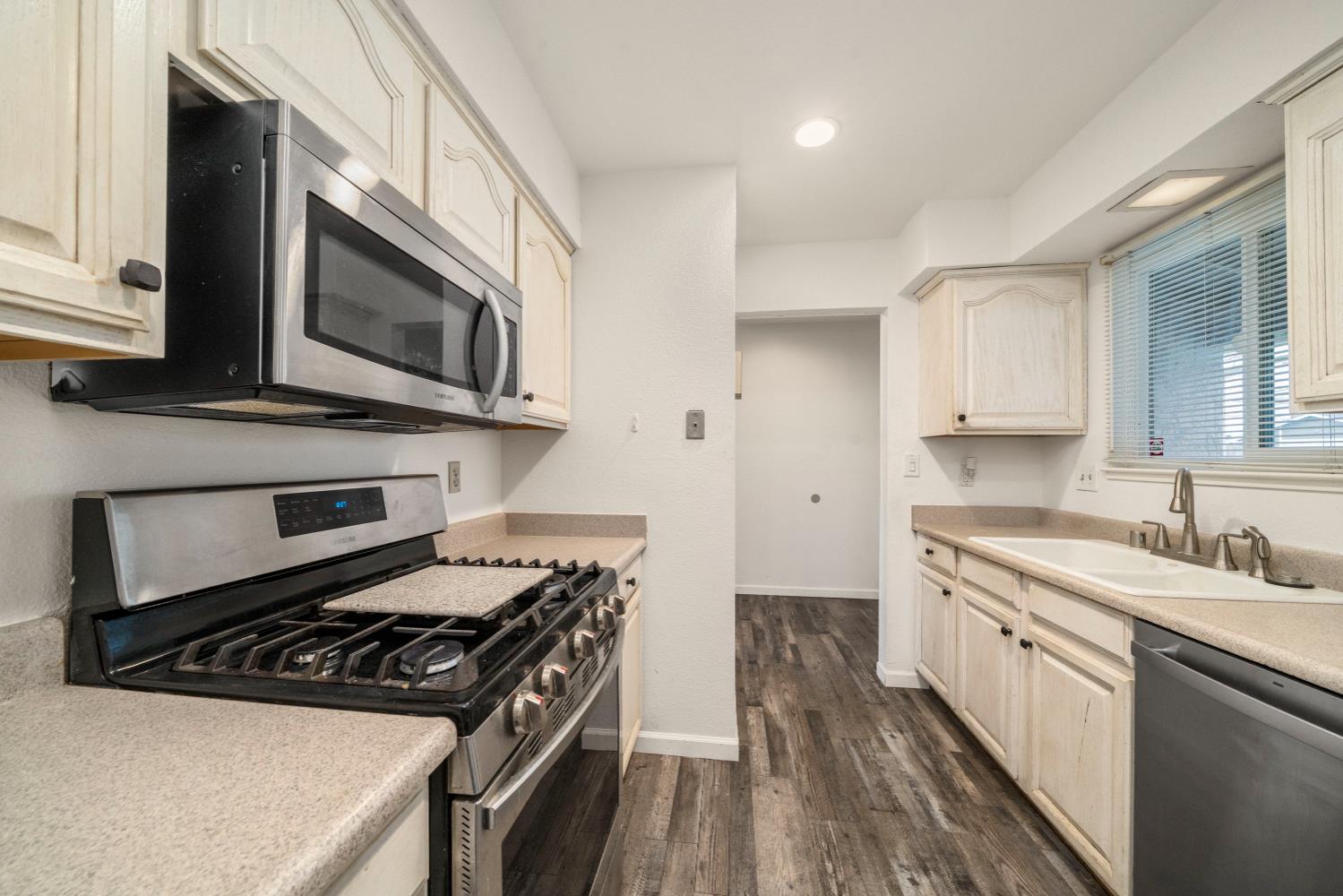 7358 Candlelight Way Citrus Heights, CA 95621 - Photo 7 of 45 a kitchen with appliances a sink and cabinets