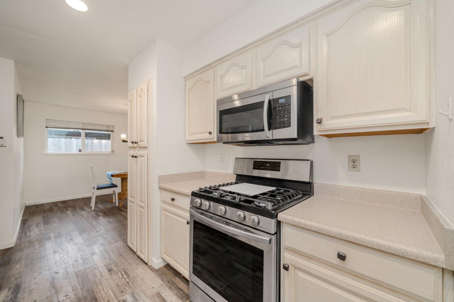 7358 Candlelight Way Citrus Heights, CA 95621 - Photo 8 of 45 a kitchen with stainless steel appliances a white stove top oven and sink