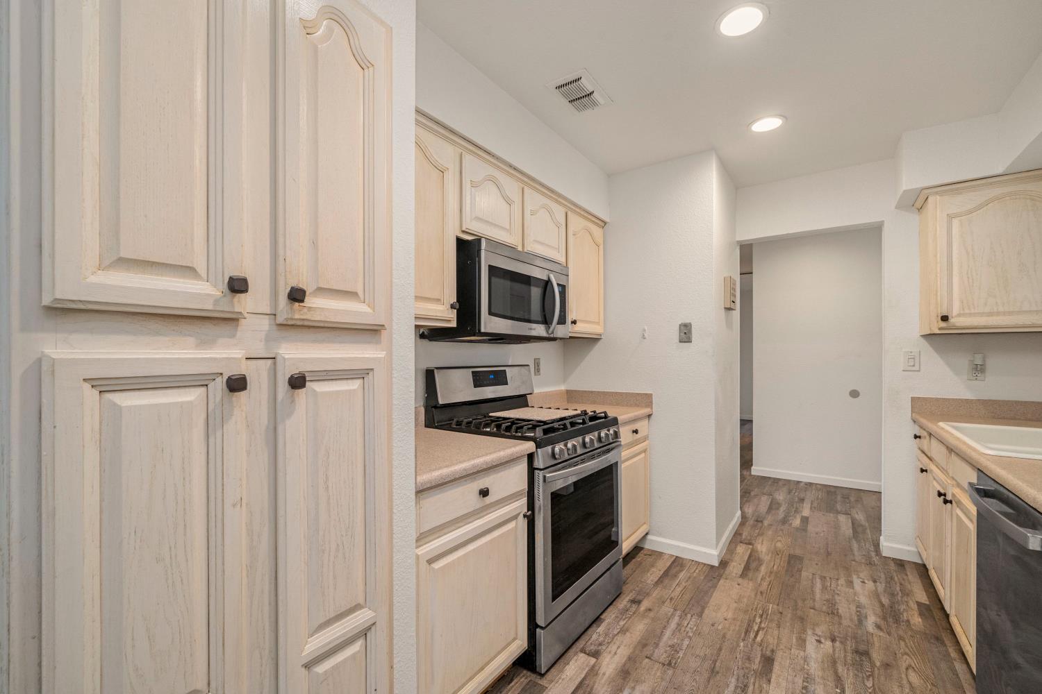 7358 Candlelight Way Citrus Heights, CA 95621 - Photo 10 of 45 a kitchen with granite countertop a stove top oven sink and cabinets