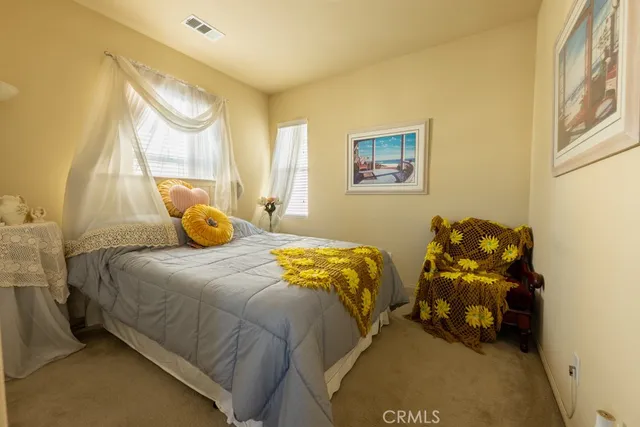 a bed sitting in a bedroom next to a window