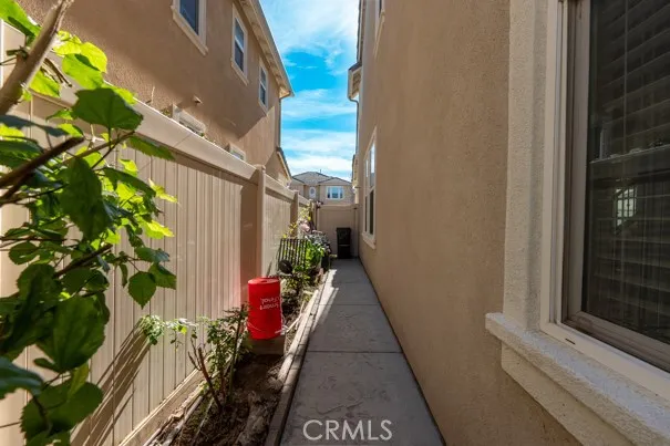 a front view of a building with garden and trees