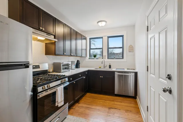 a kitchen with stainless steel appliances granite countertop a stove a sink and a refrigerator