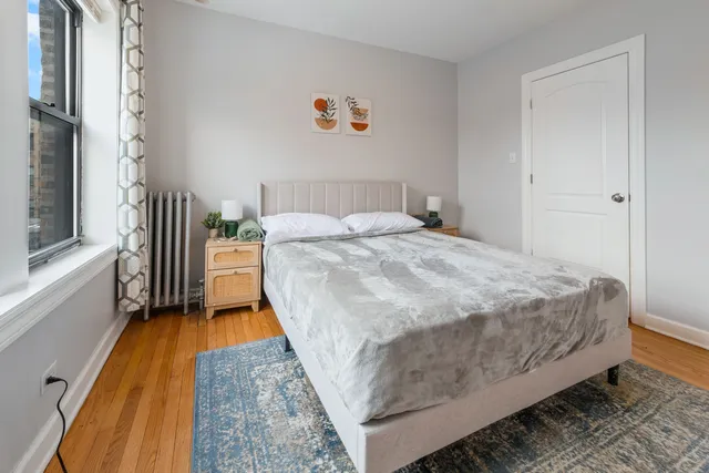 a bed sitting in a bedroom next to a window
