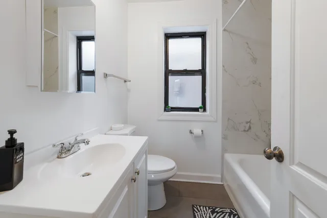 a bathroom with a sink toilet and shower