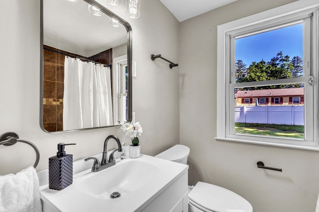 24 Capitol Road Springfield, MA 01119 - Photo 20 of 30 a bathroom with a toilet sink and mirror