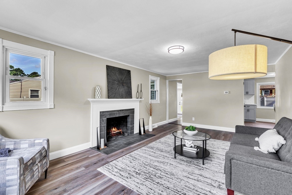 24 Capitol Road Springfield, MA 01119 - Photo 4 of 30 a living room with furniture and a fireplace