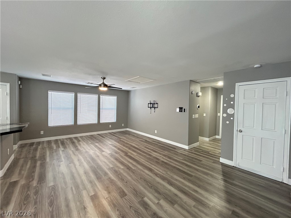 6538 Elm Spring Las Vegas, NV 89148 - Photo 6 of 29 Laminate flooring extends throughout this versatile living area, complemented by abundant natural light.