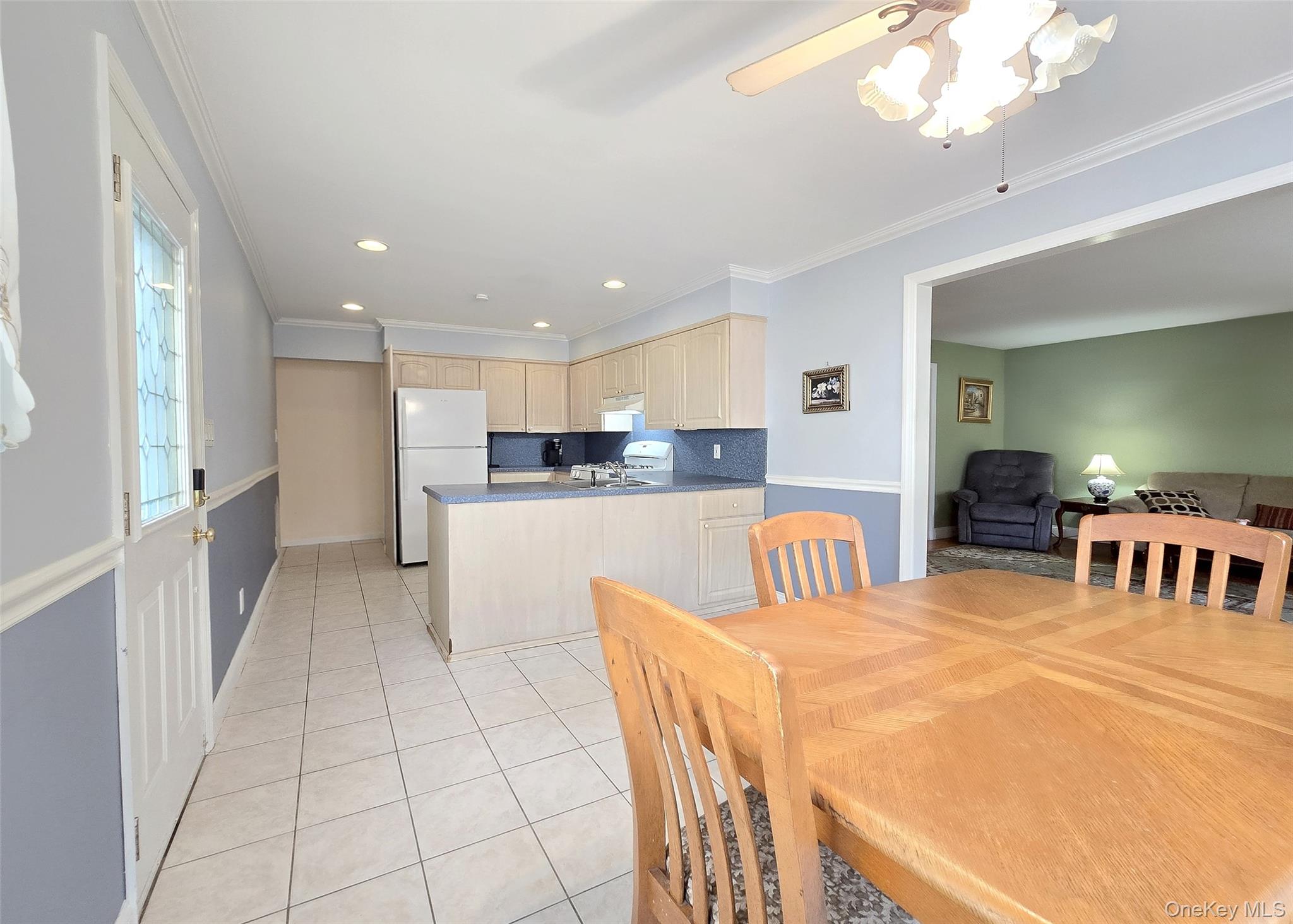 585 Pulaski Road Kings Park, NY 11754 - Photo 12 of 28 a kitchen with stainless steel appliances kitchen island granite countertop a refrigerator a stove a sink dishwasher with a dining table and chairs