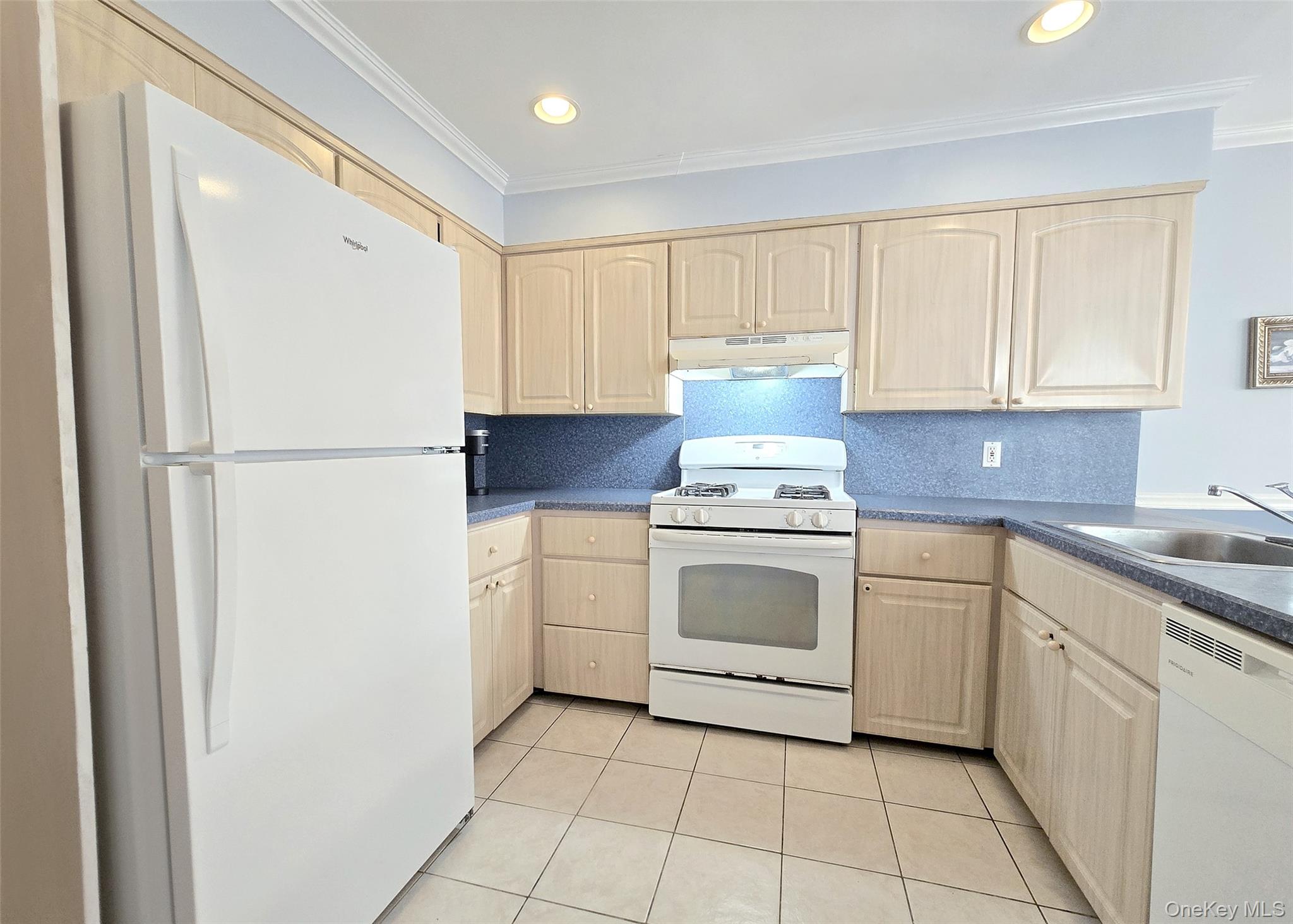 585 Pulaski Road Kings Park, NY 11754 - Photo 14 of 28 a kitchen with a stove sink and cabinets
