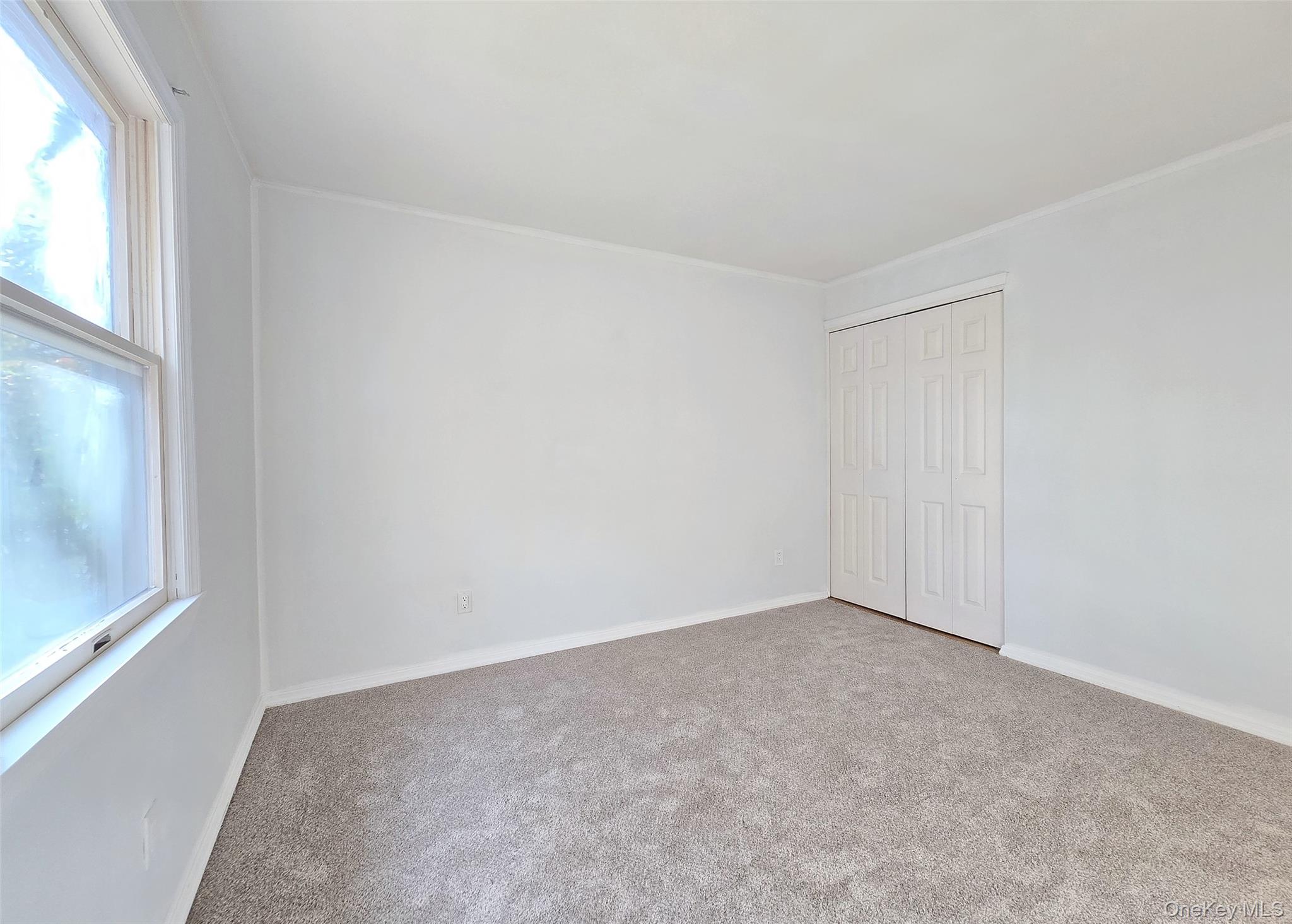 585 Pulaski Road Kings Park, NY 11754 - Photo 15 of 28 an empty room with windows